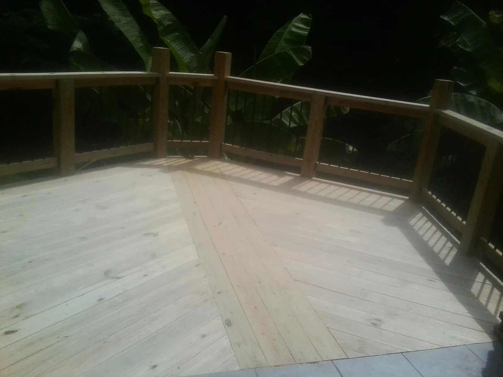 New wood deck and railing built off the back of a home in Swanzey